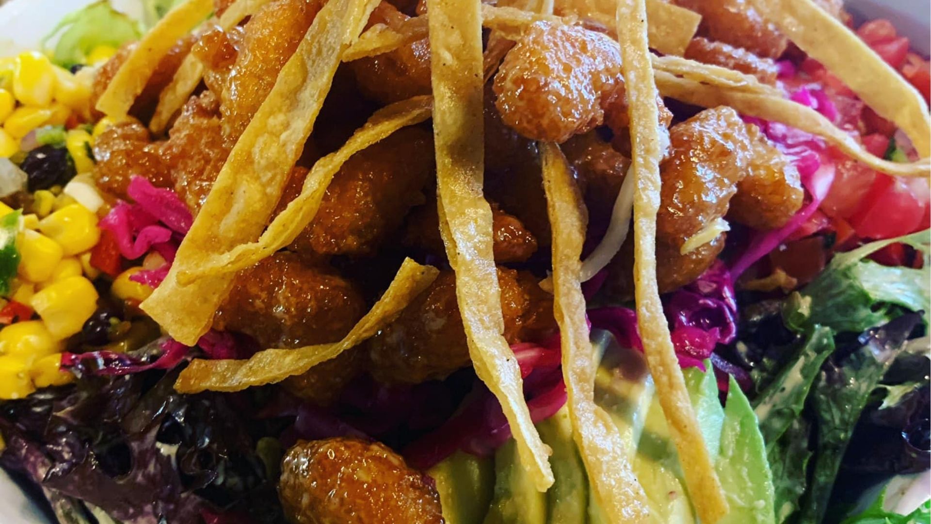 A colorful spread of authentic Mexican street tacos with fresh toppings, accompanied by vibrant, handcrafted cocktails on a rustic wooden table, capturing the essence of Atwater Street Tacos' dining experience.