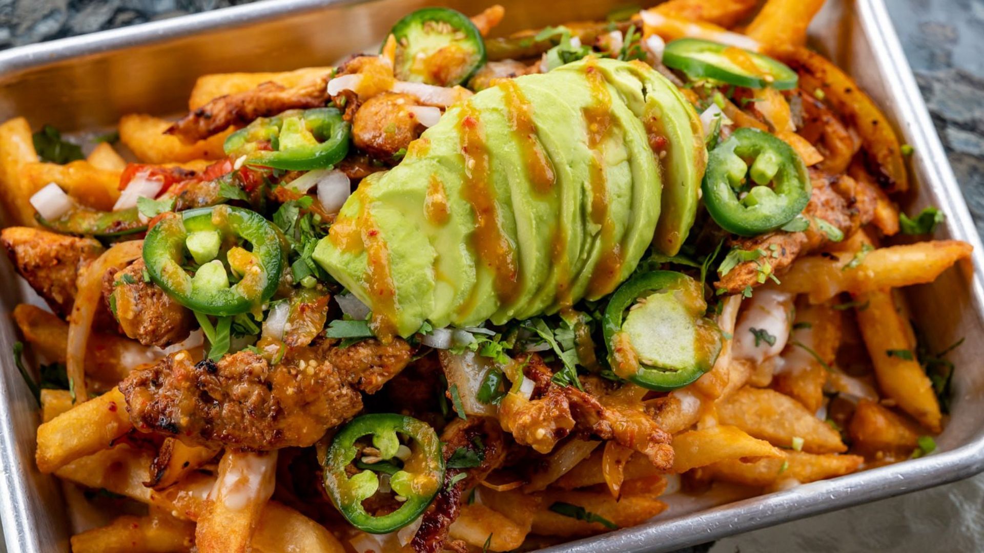 Plate of authentic Mexican street tacos with vibrant toppings at Atwater Street Tacos, Flat Rock.