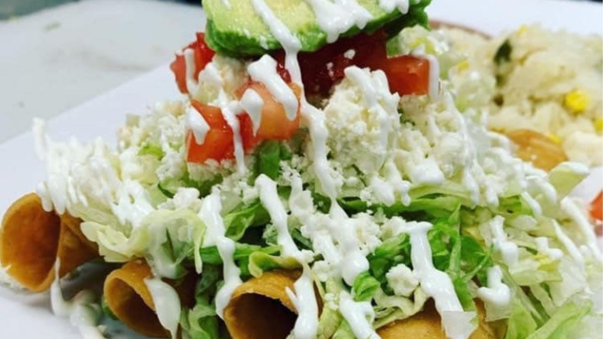 A vibrant, colorful spread of authentic Mexican street tacos, with a variety of fillings, accompanied by a refreshing margarita, representing the inviting atmosphere of Atwater Street Tacos, Monroe location.